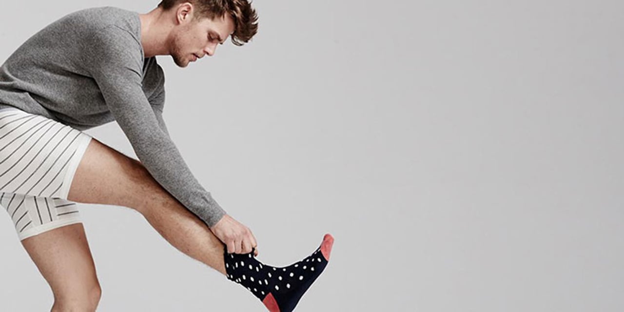 Many balancing on one foot putting on socks