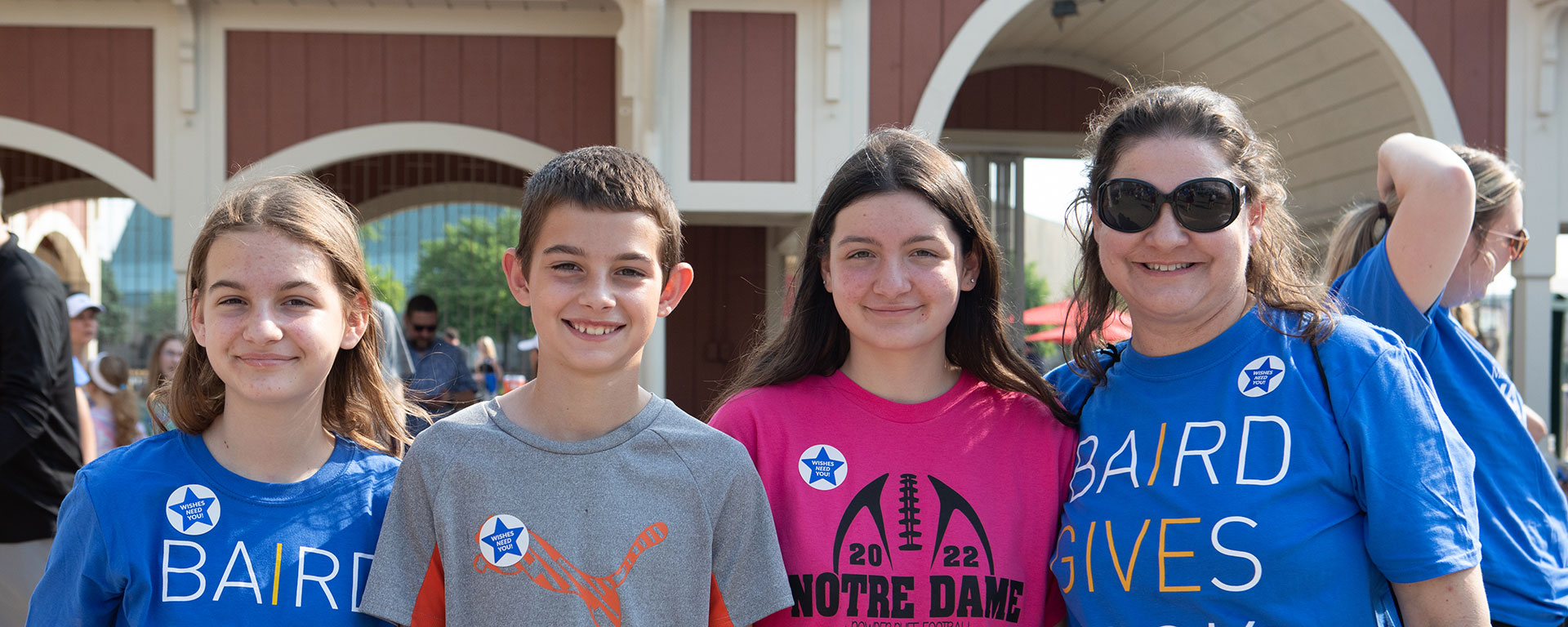 Woman and three children standing as a group