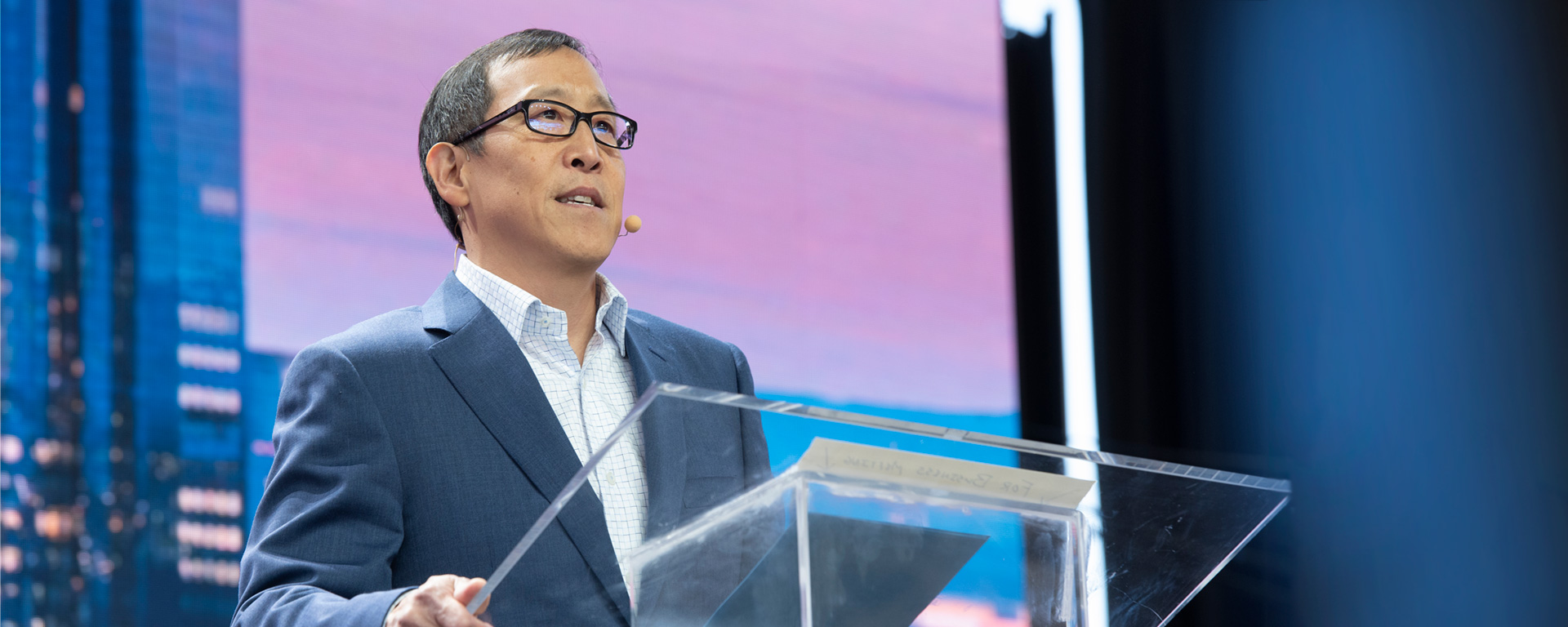 Gordon Pan speaking at a podium.