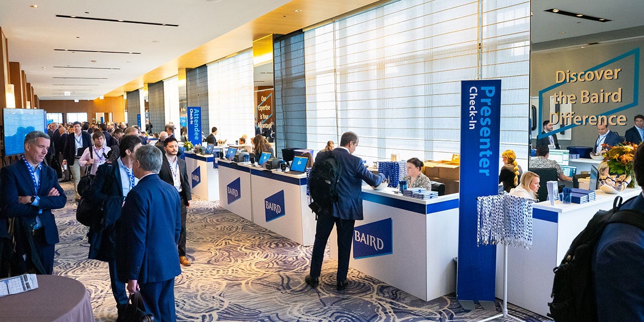 Attendees in the check-in area of a Baird Conference