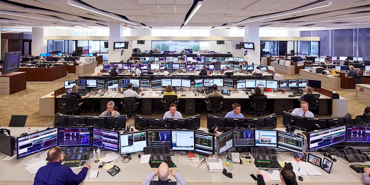 Baird trading floor wide angle shot of traders at desks looking at computers.