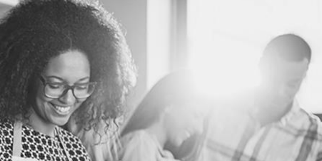 Woman smiling while cooking with friends