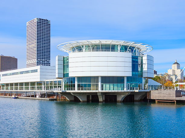 Discovery World’s circular building on Milwaukee’s lakefront with Baird office building rising in the background.